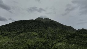 Bener Meriah, August 23, 2025. Vertical aerial view of Mount Burni Telong. The camera drone moves backward and slowly descends, revealing the lush tropical forest and farmland below - Powered by Shutterstock - Get 15% off with code: PIKWIZARD15