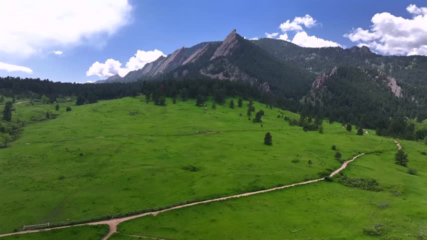 Spring summer morning blue sky Flatirons Chautauqua Park Boulder Colorado aerial drone Shanahan Ridge hiking trail Green Flatirons Mountain front range Rocky Mountains Royal Arch circle right motion