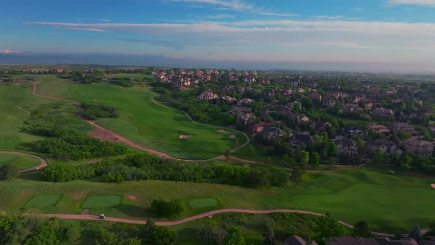 Summer golfing driving range The Ridge North Castle Pines Village Golf Course aerial drone Colorado golf cart front range neighborhood homes spring green grass morning sunrise golden hour circle right
