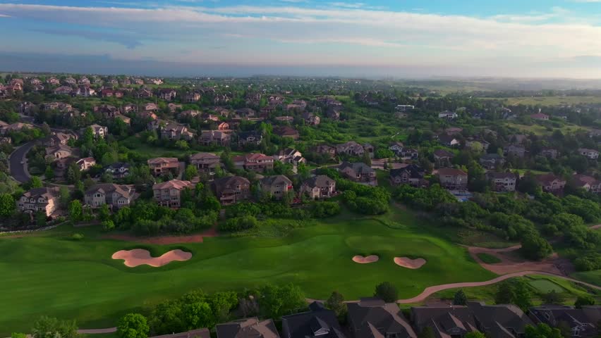 Summer golfing driving range The Ridge North Castle Pines Village Golf Course aerial drone Colorado sand trap front range neighborhood homes spring green grass morning sunrise golden hour circle right