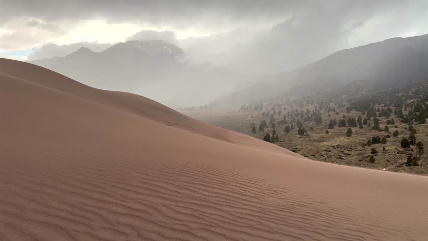 High Winds Great Sand Dunes National Park Spring summer stormy foggy cloudy raining mist Crestone Needle peak Colorado Sangre de Cristo range Rocky Mountains magical large amounts of sand dune hills