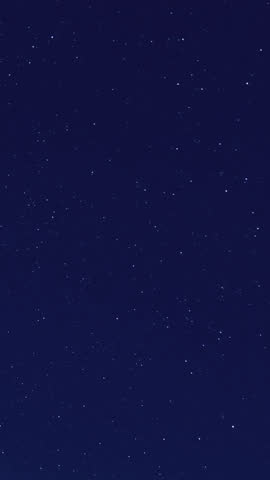 Astrophotography time-lapse capturing star trails over sand dunes, with the Milky Way rotating in the night sky, creating a mesmerizing and cosmic atmosphere—ideal for celestial visuals and desert.