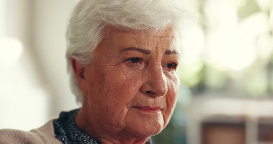 Senior woman, thinking and stress in home with dementia news, anxiety and lonely in retirement. Sad, elderly person with depression and thoughtful in house with alzheimer or contemplating memory loss