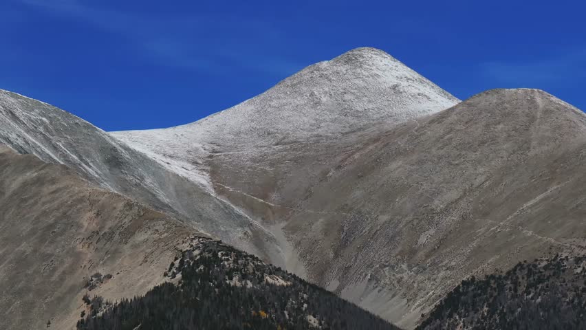 Cool autumn fall morning clear blue skies trail up 14er Mt Mount Shavano aerial drone Colorado Trail Tabeguache Peak Aspen Trees yellow orange colors snow dusting Rocky Mountains parallax right motion
