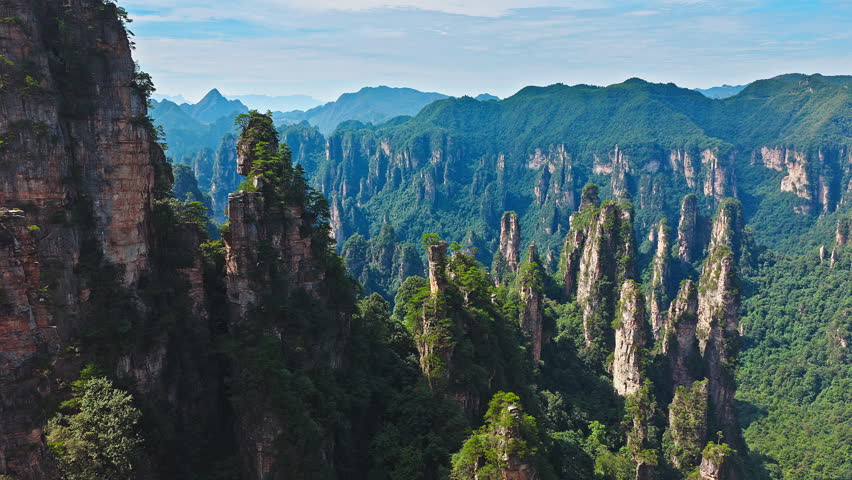 Majestic Zhangjiajie national forest park: towering sandstone pillars emerging from lush green forest, Wulingyuan Scenic Area, Hunan Province, China.