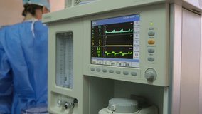 Medical ventilator monitoring patient vital signs during intricate surgical procedure, with medical professionals working carefully in background of sterile operating room - Powered by Shutterstock - Get 15% off with code: PIKWIZARD15