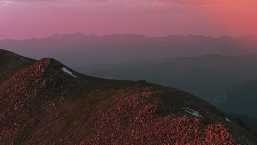 Notch Mountain shelter Mount of the Holy Cross Halo Ridge aerial drone Colorado 14er peak pink rain clouds golden hour vibrant sunset on Rocky Mountains Gore Sawatch Range Vail Minturn circle left