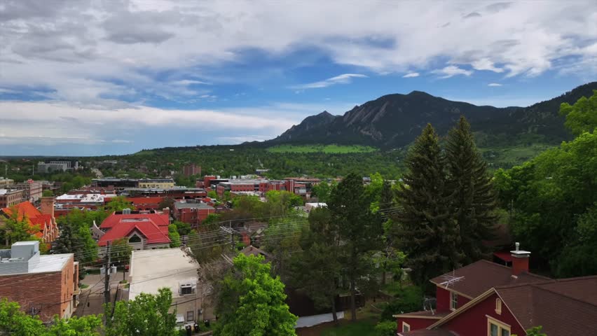 Front range college town of University of Boulder Colorado Chautauqua Park Flatirons aerial drone summer spring Green mountain Pearl Street Mall Eben G Fine Boulder creek blue sky sunny upwards motion