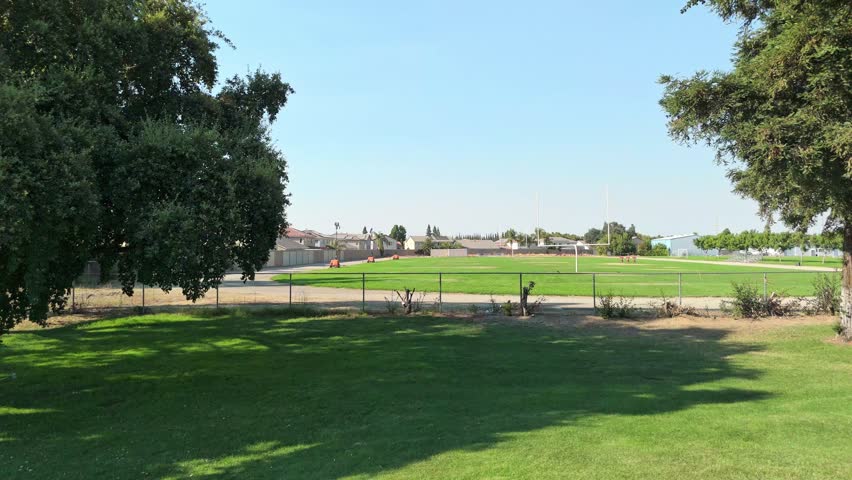 Ascending drone view of Sierra View neighborhood in Oakdale, California, with suburban homes, quiet streets, and Central Valley scenery, ideal for residential and community stock footage.