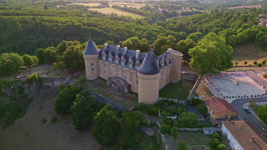 Tilted down drone panorama from the historical Chateau de Rochechouart castle in sunny day, Rochechouart, Haute-Vienne, France.