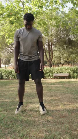 Young athlete stretching in park slow motion montage