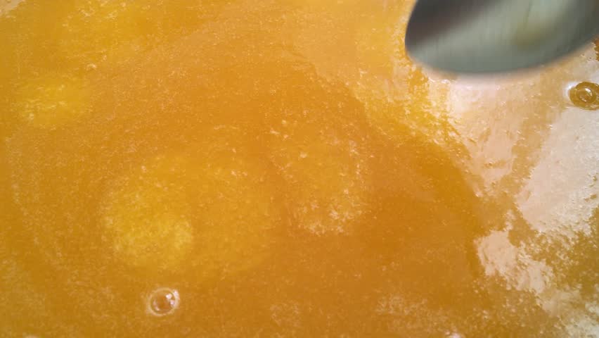 Stirring with a spoon when making homemade apricot juice