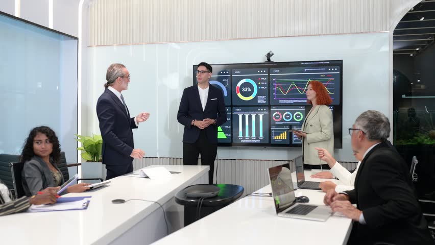 Business team in modern meeting room discussing data analytics on digital screen with charts and graphs, representing teamwork, strategy, innovation, and corporate success. - Powered by Shutterstock - Get 15% off with code: PIKWIZARD15