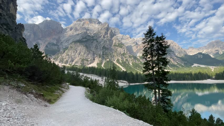 A stunning panoramic shot of Lago di Braies (Pragser Wildsee), a famous alpine lake in the Dolomites, a UNESCO World Heritage Site in South Tyrol, Italy.