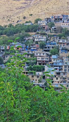 Stepped hillside village with stone buildings nestled in mountainous terrain, showcasing traditional architecture and regional adaptation.  
📍Kamalla village, Hawraman Takht 