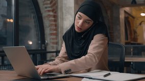 Arabian muslim business woman in hijab businesswoman working in office multitask talking phone browsing laptop online service with papers documents busy female girl finishing smartphone call chatting - Powered by Shutterstock - Get 15% off with code: PIKWIZARD15