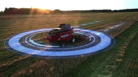 Aerial view of an autonomous combine harvester working in a golden wheat field at sunset. Futuristic technologies in agriculture. Unmanned vehicles harvest crops. GPS assisted navigation. 4k footage - Powered by Shutterstock - Get 15% off with code: PIKWIZARD15