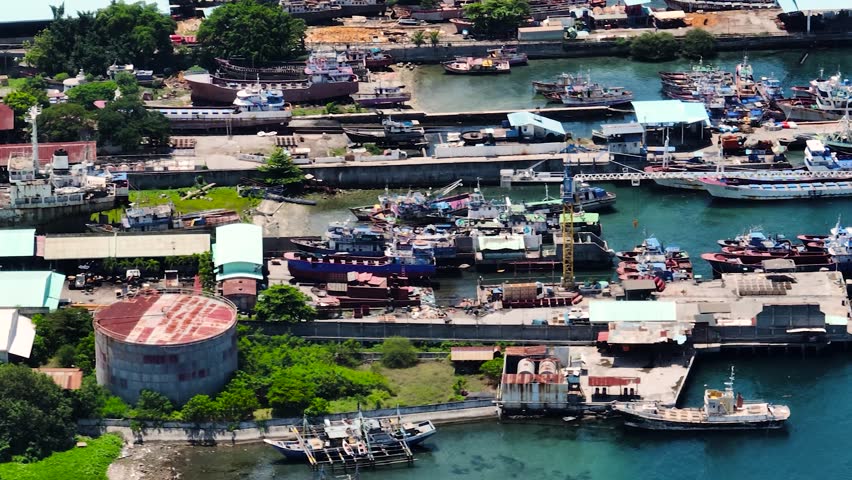 Port with fishing boats with sunlight reflection over the sea. General Santos, Philippines. Mindanao.