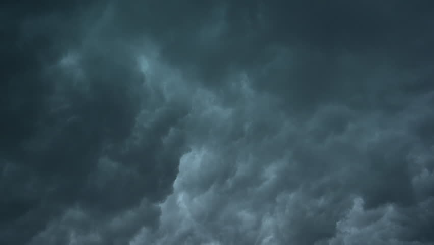 Stormy rainy dark grey blue clouds rolling in the sky. Timelapse