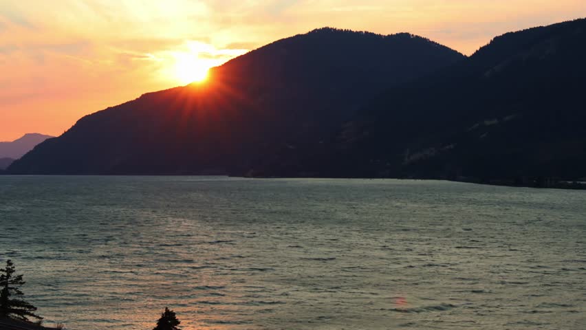 Sunset Behind Mountain Ridge Over Ocean Bay