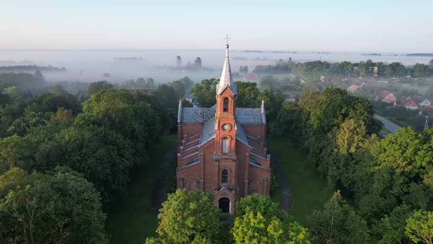Church in the fog dawn in Krakes Lithuania