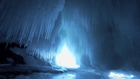 Majestic lateral dolly shot massive ancient ice cave. Huge glittering transparent icicles, ice formations in mystical grotto. Severe North winter landscape, slow motion, natural wonder, frozen kingdom - Powered by Shutterstock - Get 15% off with code: PIKWIZARD15