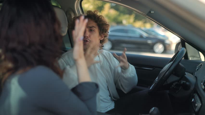 A toxic couple screams at each other inside a vehicle. Both are angry and upset, showing frustration and sadness during a heated emotional confrontation.