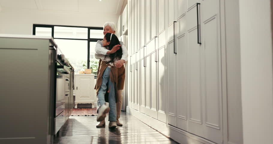 Love, grandmother and grandchild with hug in kitchen for baking support, bonding and recipe success. Happy family, senior woman and girl with apron in home for culinary skills and cooking achievement