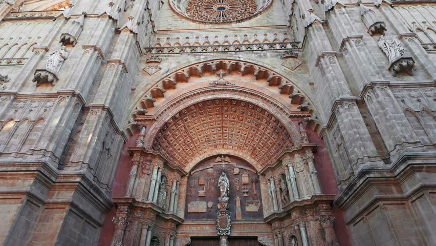 Beautiful facade of the Cathedral of Santa Maria of Palma in Palma de Mallorca, Balearic Islands, Spain. Impressive Gothic architecture with intricate stone carvings, a landmark of Majorca island