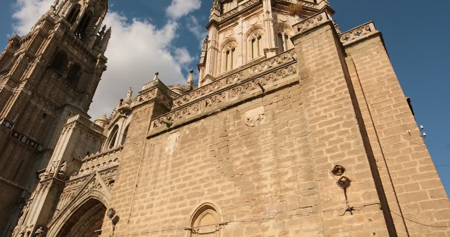 Magnificent historic facade of the Cathedral of Saint Mary of Toledo in Castilla-La Mancha, Spain. Impressive Gothic building in the heart of the Toledo old town. Slow motion steadicam footage