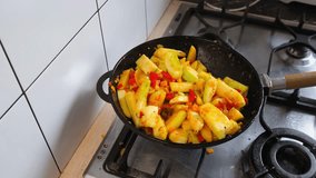 Fresh vegetables are being stir-fried in a pan, showcasing colorful bell peppers, zucchini, and spices. This culinary activity highlights healthy cooking techniques and vibrant flavors - Powered by Shutterstock - Get 15% off with code: PIKWIZARD15