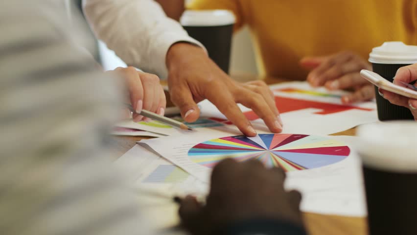 close up hand designer team brainstorming and choosing color for graphic design working or client asking advise with chromatic consultation at designer agency office. Variegated. business people paper