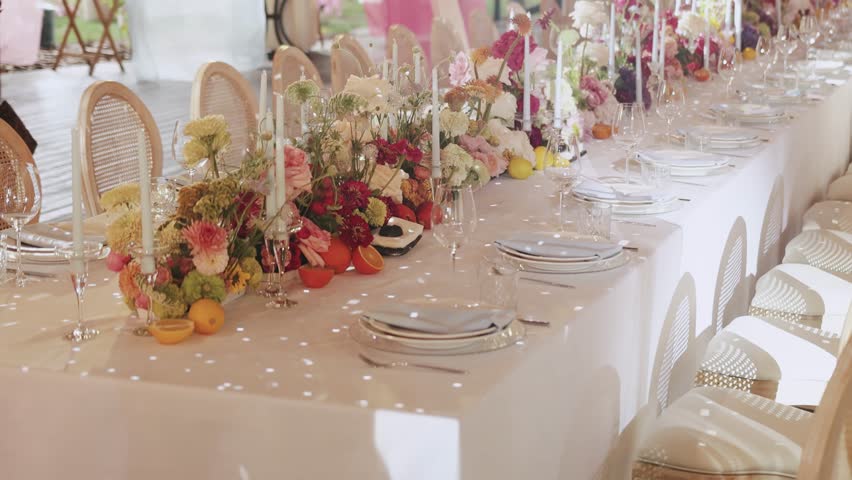 An elegantly arranged wedding table adorned with stunning flowers and soft candles, ideal for any joyful celebration