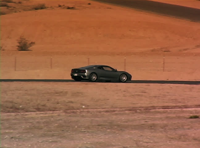 Two cars driving around race track