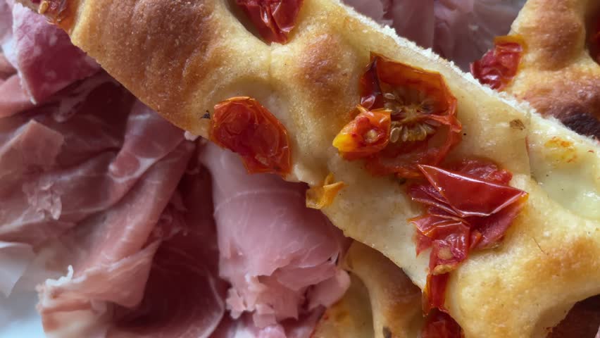 Great 4K cinematic footage with delicious Italian food, cured meat, bread, focaccia, dry tomatoes, olives. Real food made with love and passion.