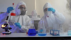 A team of medical researchers in full protective suits examines a chemical compound. They are working together in a high-security lab to develop a new vaccine for a global pandemic. - Powered by Shutterstock - Get 15% off with code: PIKWIZARD15