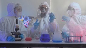 A team of medical researchers in full protective suits examines a chemical compound. They are working together in a high-security lab to develop a new vaccine for a global pandemic. - Powered by Shutterstock - Get 15% off with code: PIKWIZARD15