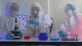 A team of scientists in full protective suits compares two different chemical samples. They are working together in a high-tech lab to find the right formula for a new cure. - Powered by Shutterstock - Get 15% off with code: PIKWIZARD15