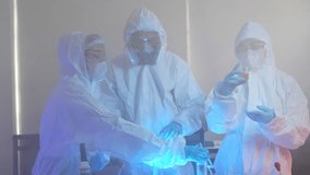 team of scientists in full protective suits compares two different chemical samples. They are working together in a high-tech lab to find the right formula for a new cure. - Powered by Shutterstock - Get 15% off with code: PIKWIZARD15