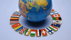 3D globe encircled by national flags of the world, symbolizing education, geography, international unity, cultural diversity, and global connection. Perfect for learning, awareness, and symbolism. - Powered by Shutterstock - Get 15% off with code: PIKWIZARD15