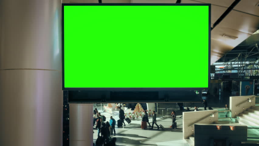 Airport Digital Billboard with Green Screen for Advertisement Display. Large digital billboard with green screen inside busy airport terminal for advertising replacement