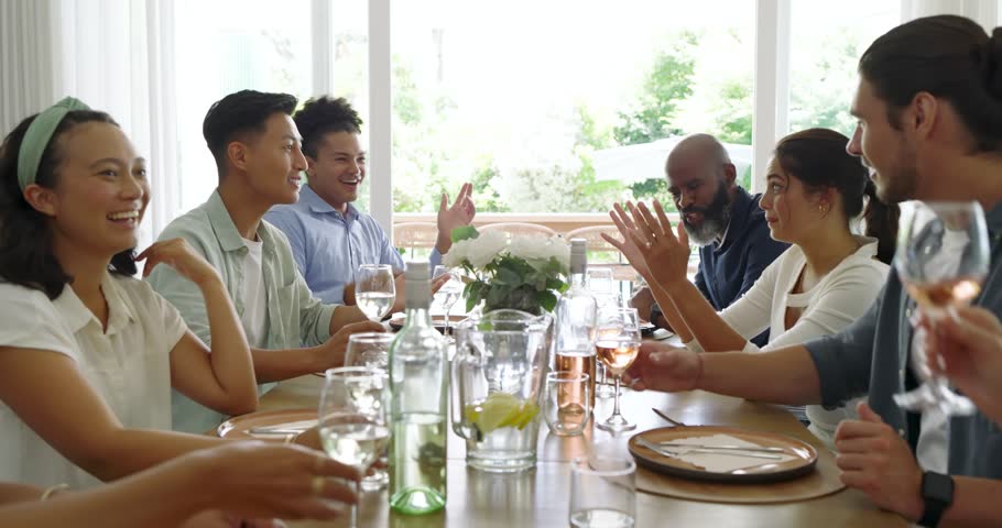 Diverse friends toasting friendship by raising wine glasses, clinking and passing bread at home. Celebration, camaraderie, socializing, domestic, cozy, vitality, leisure