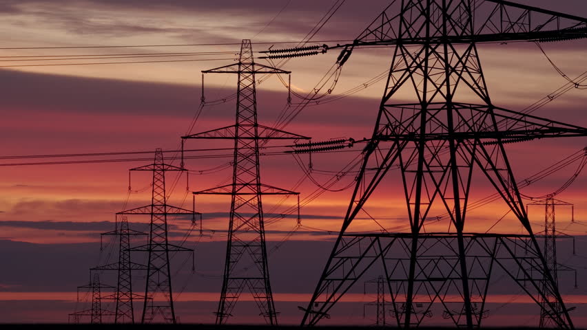 Dramatic Sunrise Over Electricity Power Transmission Pylons and Wires in the Remote Yorkshire Pennines