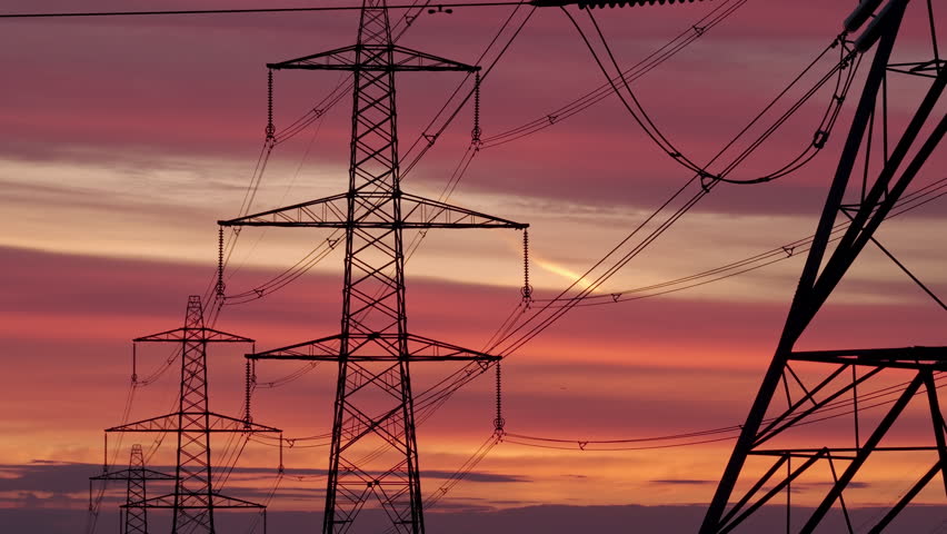 Vibrant Sunrise Over Yorkshire Pennines with Silhouette Electricity Pylons and Power Grid Infrastructure