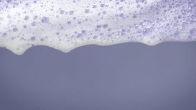 Slow-motion soap foam bubbles drift gracefully on a vibrant background, showcasing delicate, iridescent patterns and soft reflections. This serene visual captures the essence of fluid elegance. - Powered by Shutterstock - Get 15% off with code: PIKWIZARD15