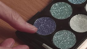 Close-up of woman applying glitter eyeshadow makeup, recorded with ambient sound. - Powered by Shutterstock - Get 15% off with code: PIKWIZARD15