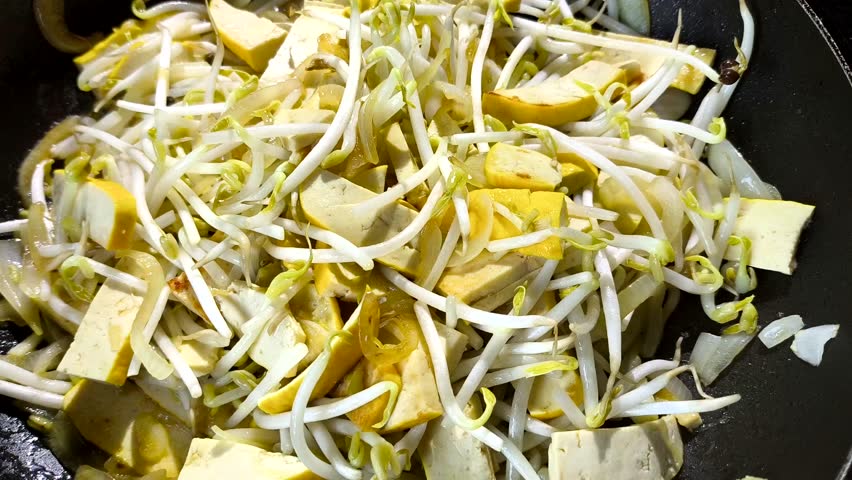 Frying tofu  with bean sprouts in pan