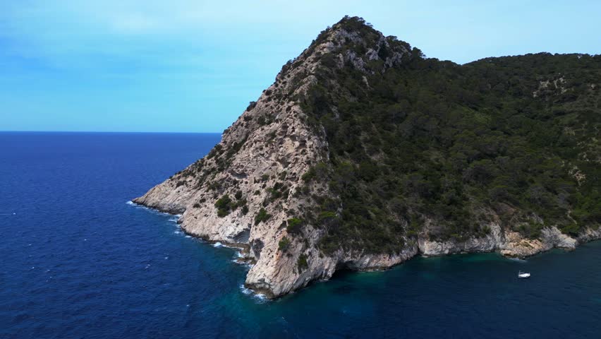 Ibiza, spain, boats mooring near rocky coast. Nice aerial view flight drone