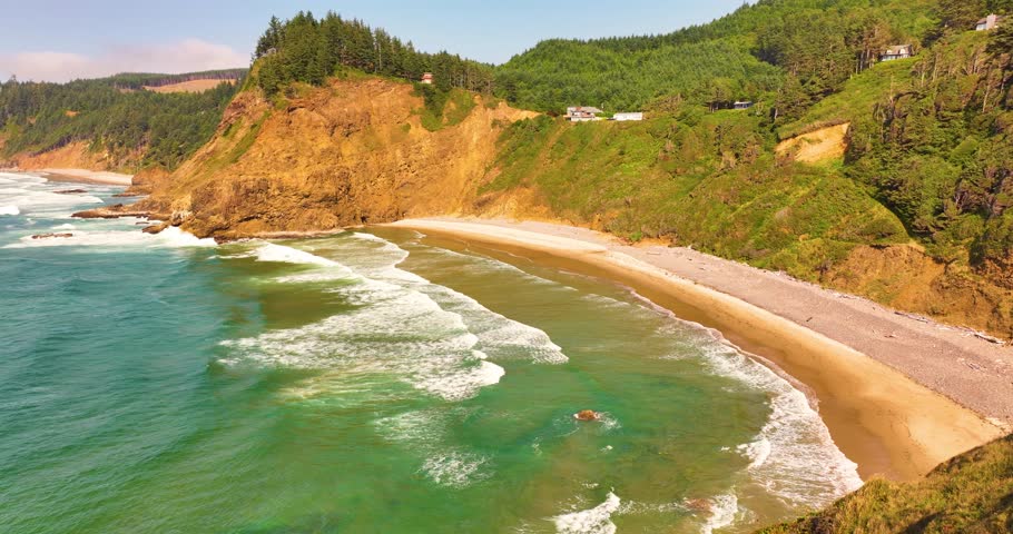 Aerial of Oregon Coastline with Forested Hills and Sandy Beaches