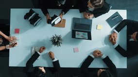 Top view of professional businessman give vr headset to diverse investors while young businesswoman looking at data analysis or marketing statistic on laptop and prepare for data sharing. Directorate. - Powered by Shutterstock - Get 15% off with code: PIKWIZARD15